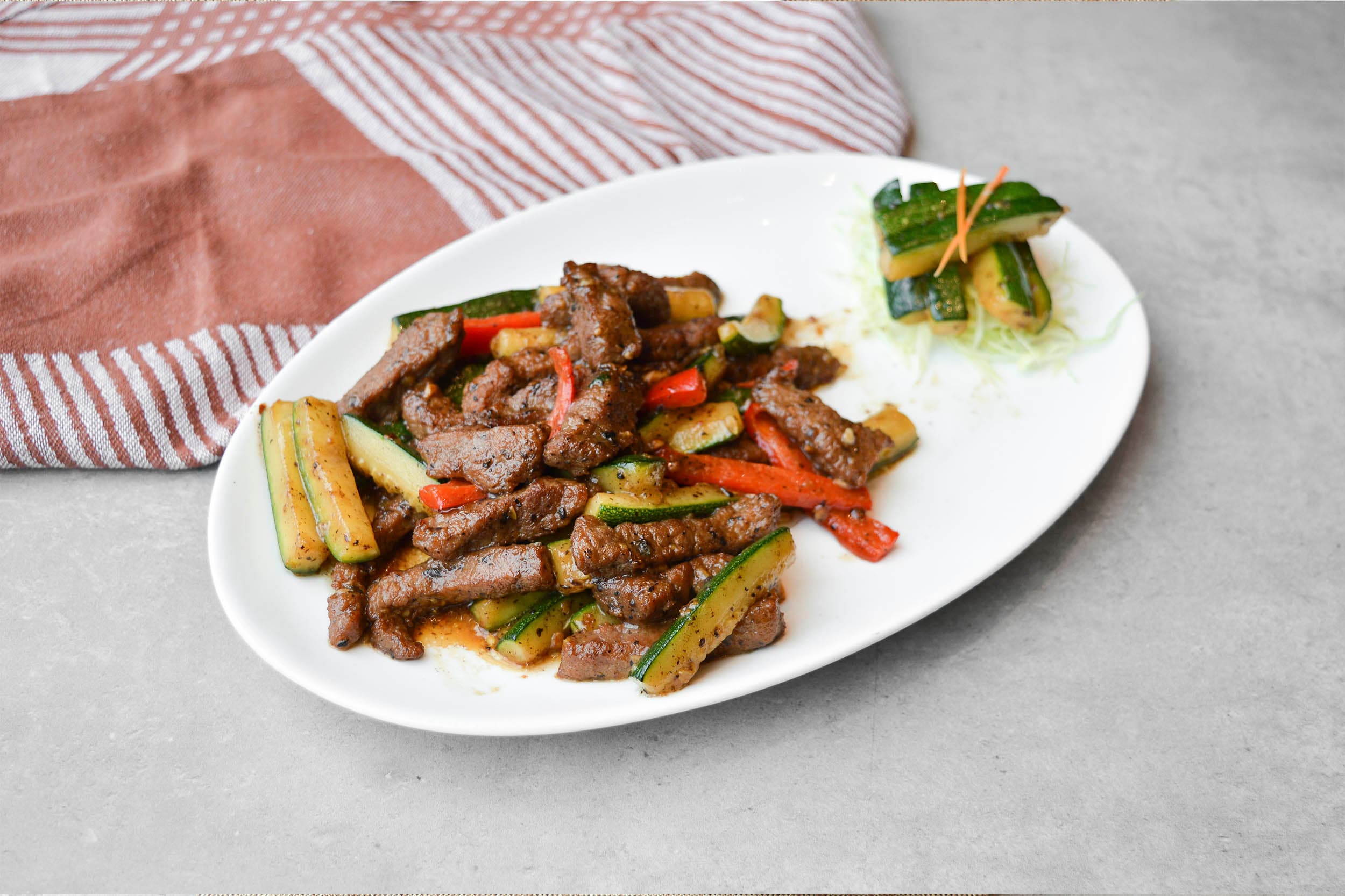 Wok-fried beef fillet with zucchini in truffle paste